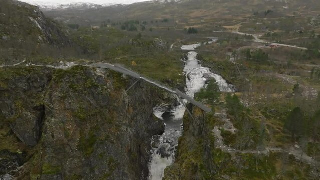 aerial view from drone of a metal bridge on extreme high altitude over canyon of Voringfossen waterfall in norway