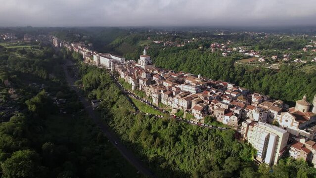 Scenic Italian town Zagarolo on long cliff with valley, aerial dolly establisher
