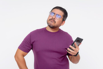 A middle aged man trying to remember the notes to write on his notepad app on his phone. Checking his schedule. Wearing a purple waffle shirt. Isolated on a white background.
