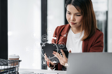 Businesswomen working with smart phone and laptop and digital tablet computer in office with...