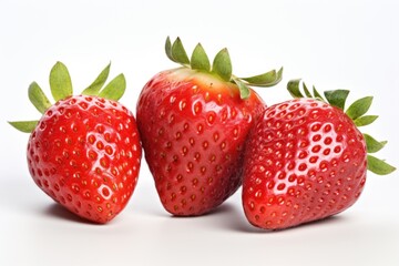 Three strawberries are sitting side by side on a white surface