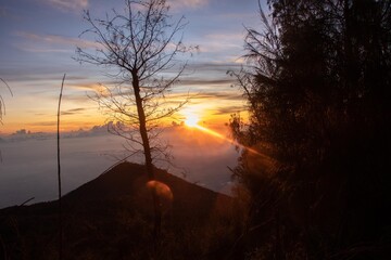 the beauty of the sunrise from the top of the mountain is like a hidden paradise behind the jungle.
