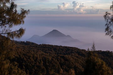 the beauty of the sunrise from the top of the mountain is like a hidden paradise behind the jungle.