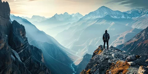 Küchenrückwand glas motiv Adventure and exploration in heart of nature. Lone traveler adorned with backpack stands triumphantly on mountain peak gazing at breathtaking panoramic. Rugged terrain dusted with snow touch of winter © Wuttichai