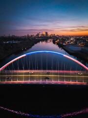 a bridge that has been lit up in blue and red: Sunset by the Lowry avenue bridge in Minneapolis, MN