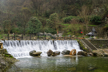 A tranquil waterfall of natural beauty that captures the tranquil essence of Xiaoyao Valley in...