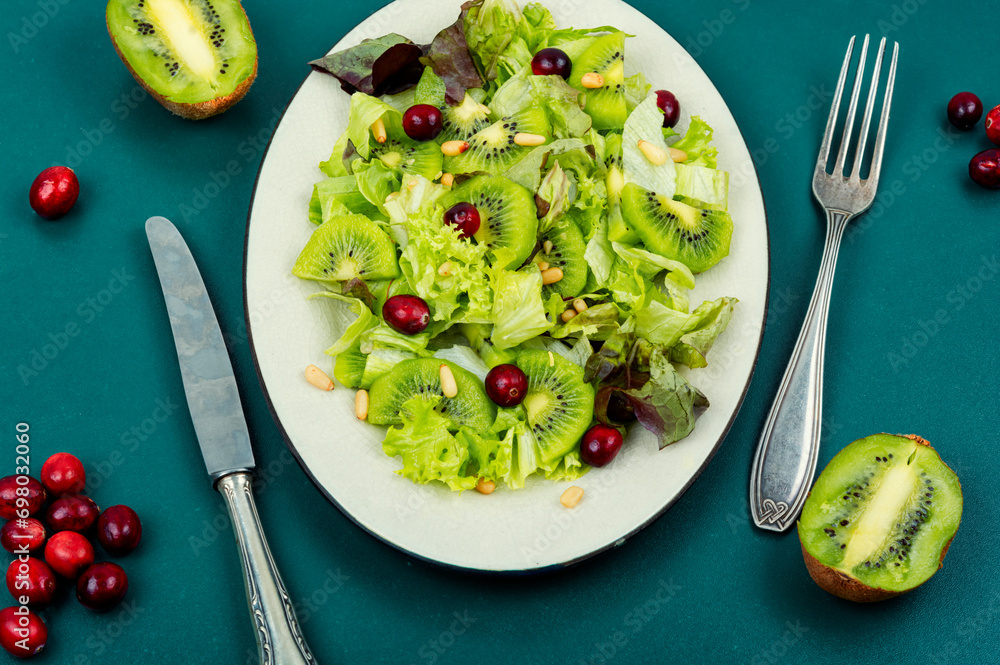 Wall mural Green salad of kiwi and lettuce.