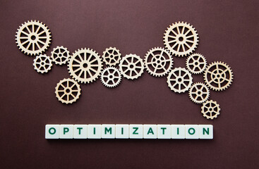 Wooden gear with the word Optimization. Technology concept and optimization.