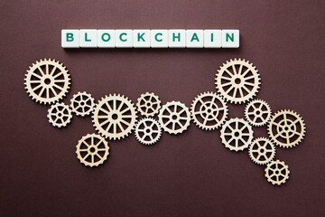 Wooden gears with word Blockchain. Cryptocurrency concept