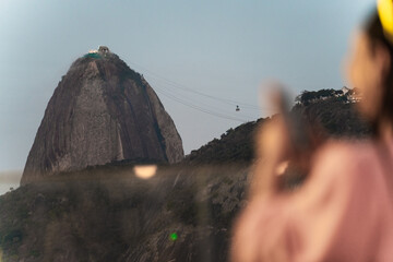 Woman Admiring the Captivating View of a Mountainside Cable Car