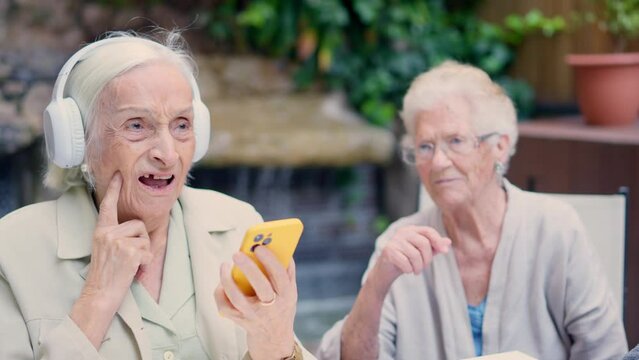 Seniors disagreeing with the music they listening to on mobile