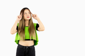 Obraz na płótnie Canvas Young asian woman long hair style in green shirt posing thinking and pointing isolated on white background