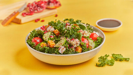 Vibrant salad Bowl lettuce, cherry tomatoes, paneer, cucumber, pomegranate; a refreshing, nutritious blend of flavors and textures with yellow background