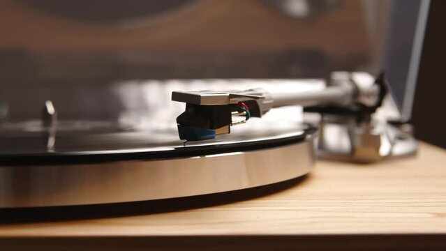 Close up of a vinyl player as the needle drops onto the record and classical music begins to play. A vintage homage to the fashion of the past century. High quality 4k footage