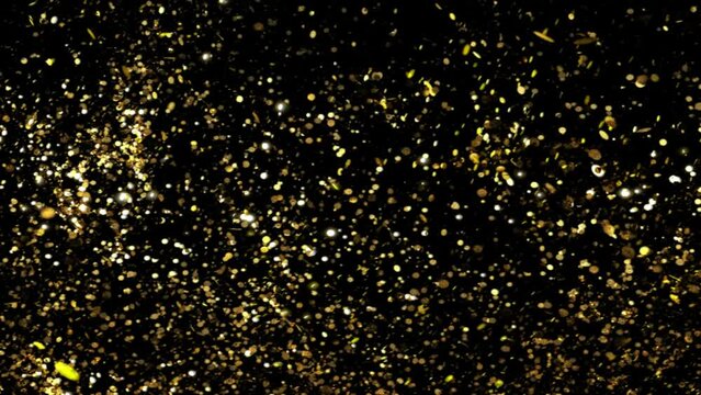 golden glitter particles explosion on black background