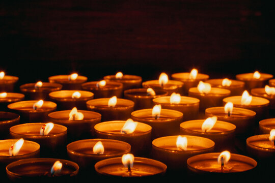 Burning candles on a dark surface. Remembrance Day