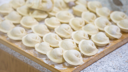 Fototapeta na wymiar Homemade handmade dumplings close-up. Selective Focus, Tinted Image, Healthy Food Concept.