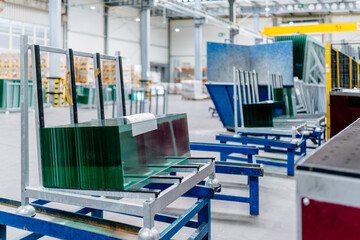 Conveyor production of large sheets of cut glass. Cut stacks of glass sheets on a pallet ready to...