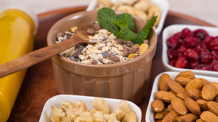 Muesli with nuts and dried cranberry in a bowl. Close up view.