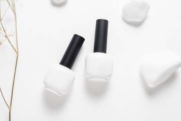 Set of white nail polish bottles on white background