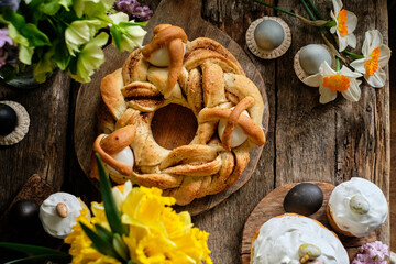 Fototapeta premium easter still life with easter wreath , color eggs and spring flowers