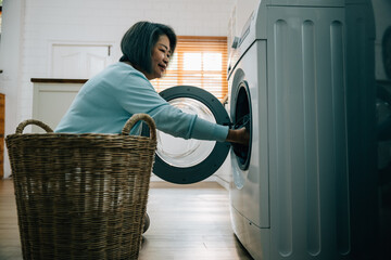 In this portrait, an old woman finds joy in working with her washing machine, putting clothes from...