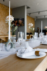 Beautiful table setting in white colors. Empty white plates. Set table for romantic dinner for two at home