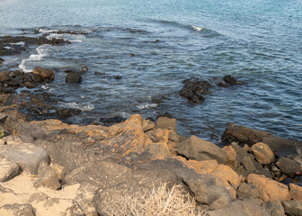 Fototapeta na wymiar Rocky Shoreline with a Clear Blue Sea View