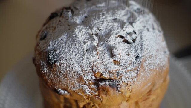 Panettone, Colomba.
Tall, soft, decorated with candied fruits and raisins. Bakery products made from soft dough. Sweet holiday bread sprinkled with powdered sugar. Traditional Italian Christmas pastri