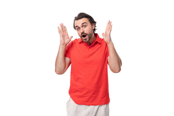 Fototapeta premium young smart caucasian brunette man with a well-groomed beard stands thoughtfully