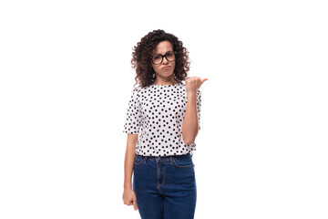 young smart dark-haired caucasian woman dressed in a blouse holding a thumbs up
