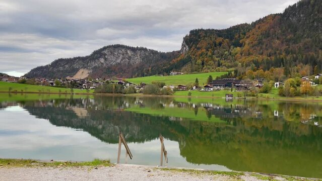 Spectacular panoramic view of Thiersee lake and mountains on cloudy day in Austria. Peaceful natural landscape with reflection on water
