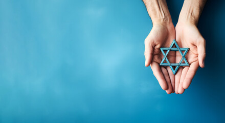 A Jewish person holding the Star of David against a blue background