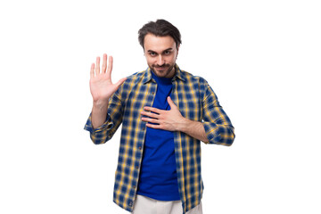 young caucasian brutal man with unshaven face dressed in a plaid stylish shirt