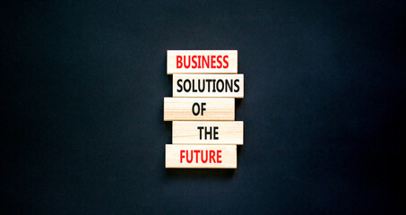 Business solutions of the future symbol. Concept words Business solutions of the future on wooden blocks. Beautiful black table black background. Business solutions of the future concept. Copy space.