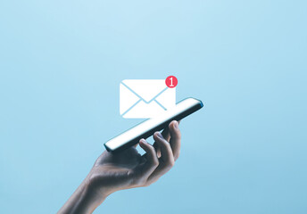 hand holding the smartphone shows the icon for new email, send an information message email. smart SMS mail on digital. business communication contact newsletter concept. marketing social media. - obrazy, fototapety, plakaty