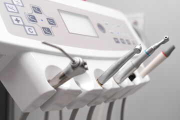 Close-up of dental instruments on a dental unit, selective focus. Various tips, ultrasonic scaler,...