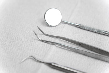 Close-up of dental instruments on a table on a white paper napkin