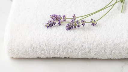 Fototapeten Purple lavender flowers on white soft towel on marble table background. © BarTa