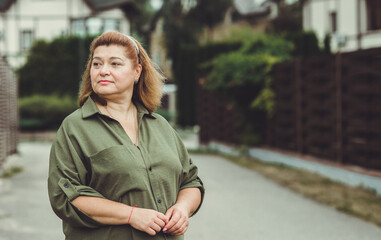 Mature plus size lady outdoor portrait at street. Middle aged People psychology concept