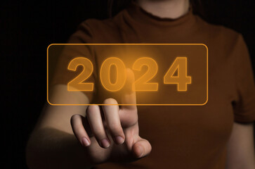 The beginning of the new year 2024. A Woman hand chooses 2024, planning and strategy for tasks in...