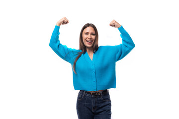 young successful well-groomed healthy brunette woman in a blue cardigan on a white background