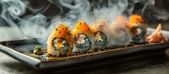 Fotobehang Sushi rolls on plate, with smoke around. © AkuAku