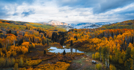 Epic Aerial Colorado Fall Season Vista Remote Wilderness Dispersed Camping Trailer. Dramatic Clouds Mountains Kebler Pass.