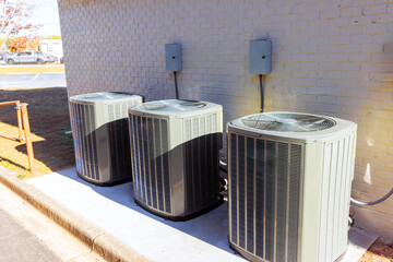 An outdoor air conditioning units has been installed on exterior facade of new house