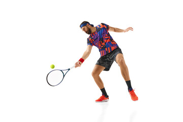 Bearded man in his 30s, tennis plater in colorful uniform practicing, returning ball with racket isolated over white background. Concept of professional sport, movement, competition, action. Ad