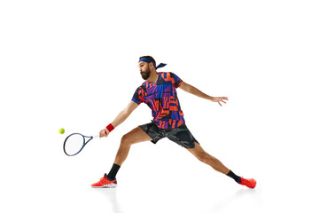 Fototapeta na wymiar Bearded man, tennis player practicing, training isolated over white background. Concept of professional sport, movement, competition, action. Ad