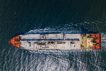 Top down view of Cement carrier vessel in transit in sea, global trade and maritime shipping. Aerial shot