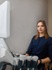 Portrait doctor doing ultrasound examinationof patient in clinic