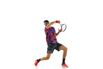 Bearded young man in colorful uniform raining, playing tennis hitting ball with racket isolated over white studio background. Concept of professional sport, movement, competition, action. Ad